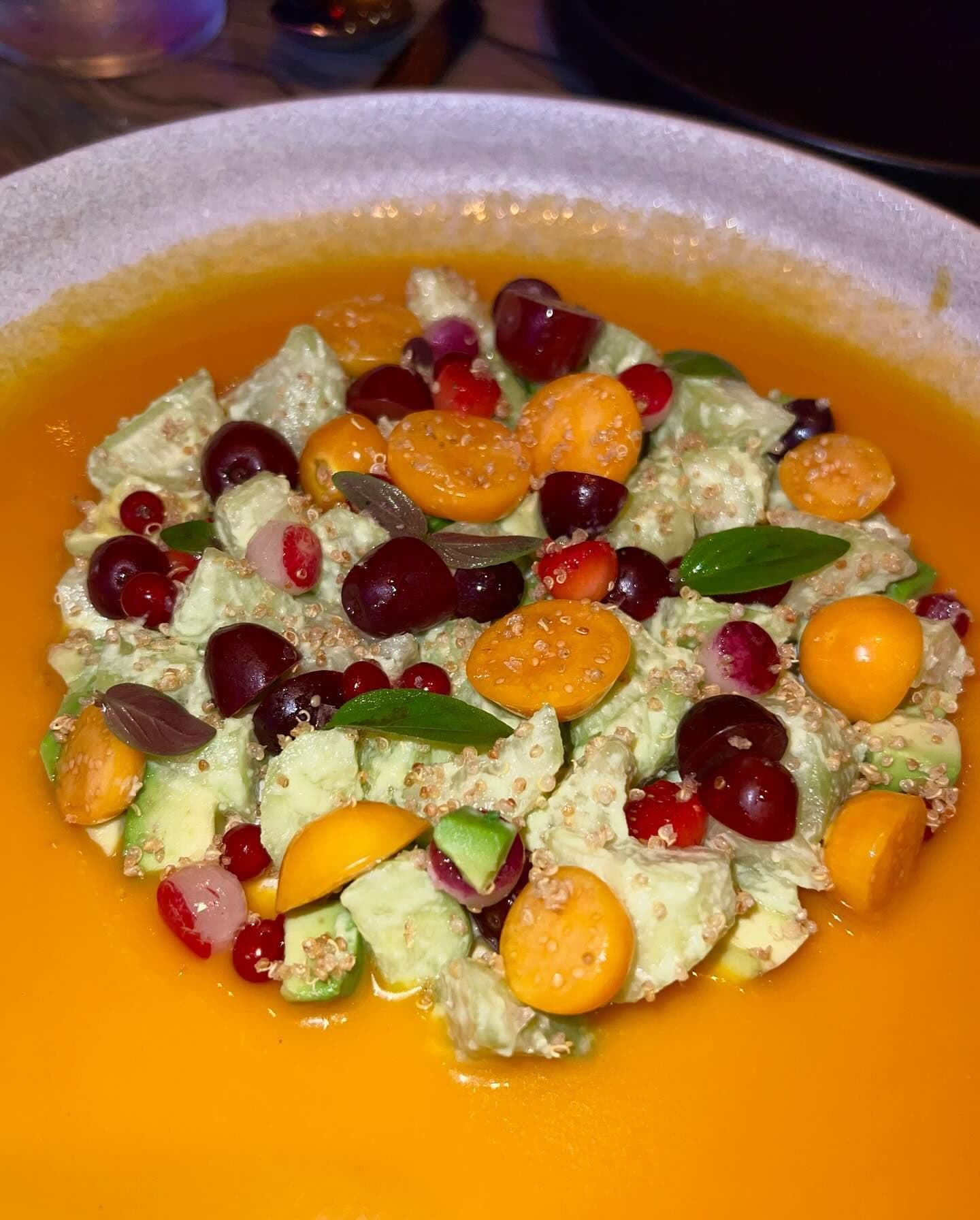 A vibrant salad featuring a medley of fresh fruits, vegetables, and quinoa artistically presented in a bowl, showcasing the type of healthy, gourmet dishes available through Booked in New York's best restaurants.
